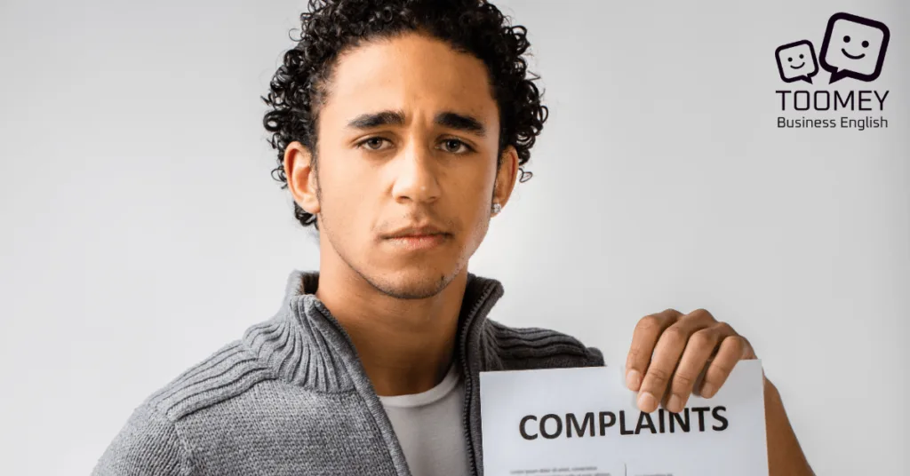 Customer holding up a list of complaints. Toomey Business English.