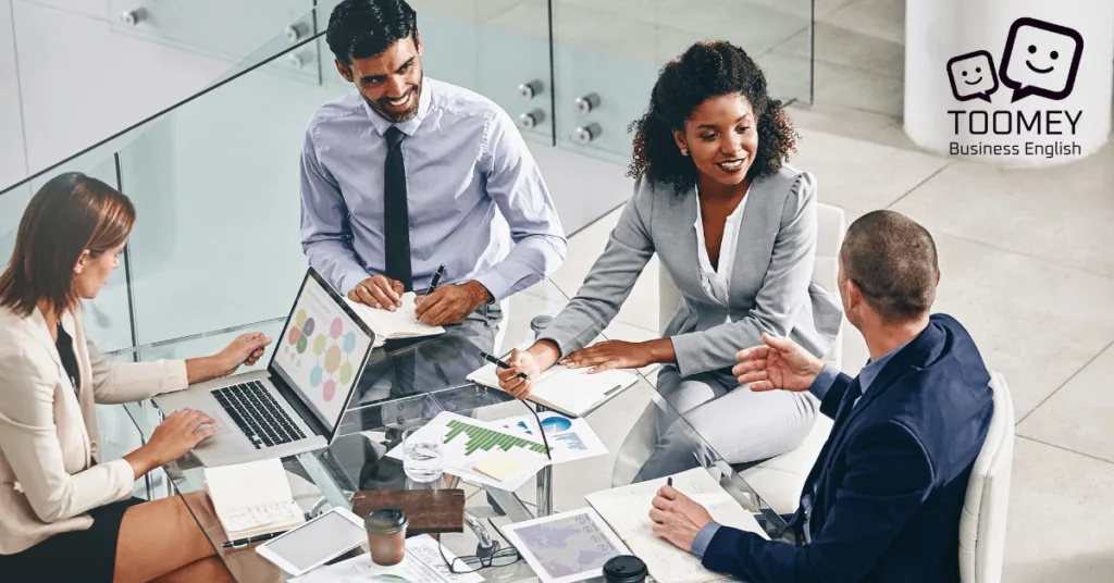 A group of business people communicating in the office. Toomey Business English.