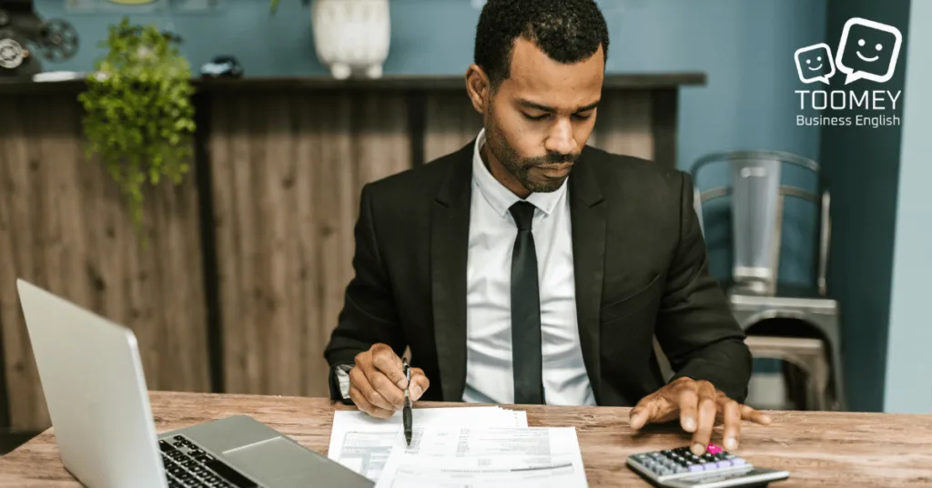 An Accountant calculating company finances. Toomey Business English.